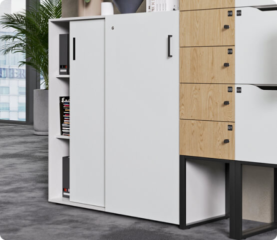 White Hushlock cabinet with sliding door next to wooden cabinets on legs
