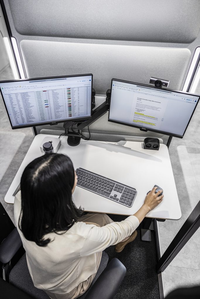Hushfree Work booth standing beside desks in an open-plan office