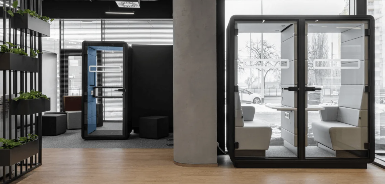 Coworking floor with desks, planters and acoustic pods