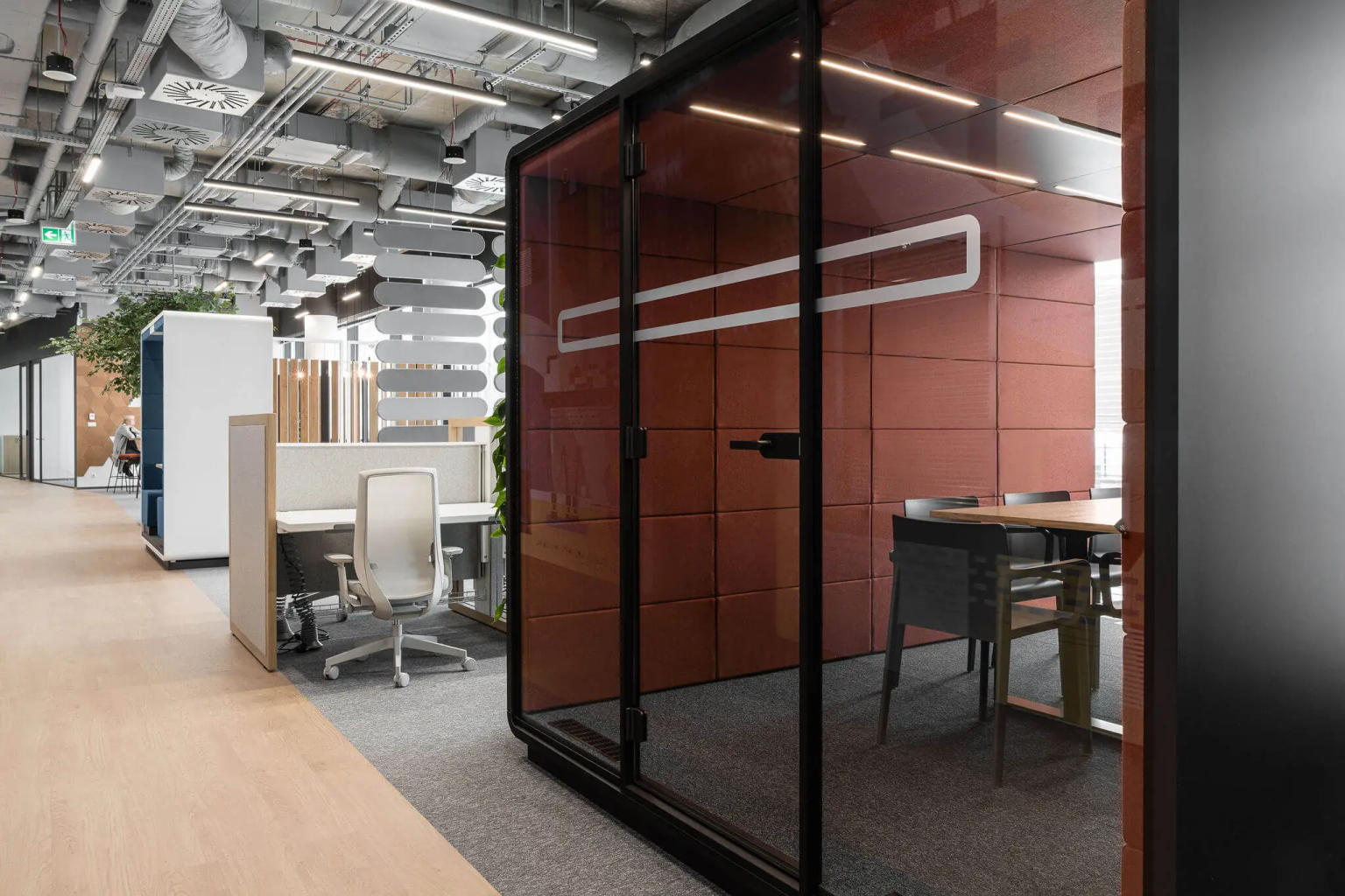Maroon Hushmeet pod with a table and chairs inside