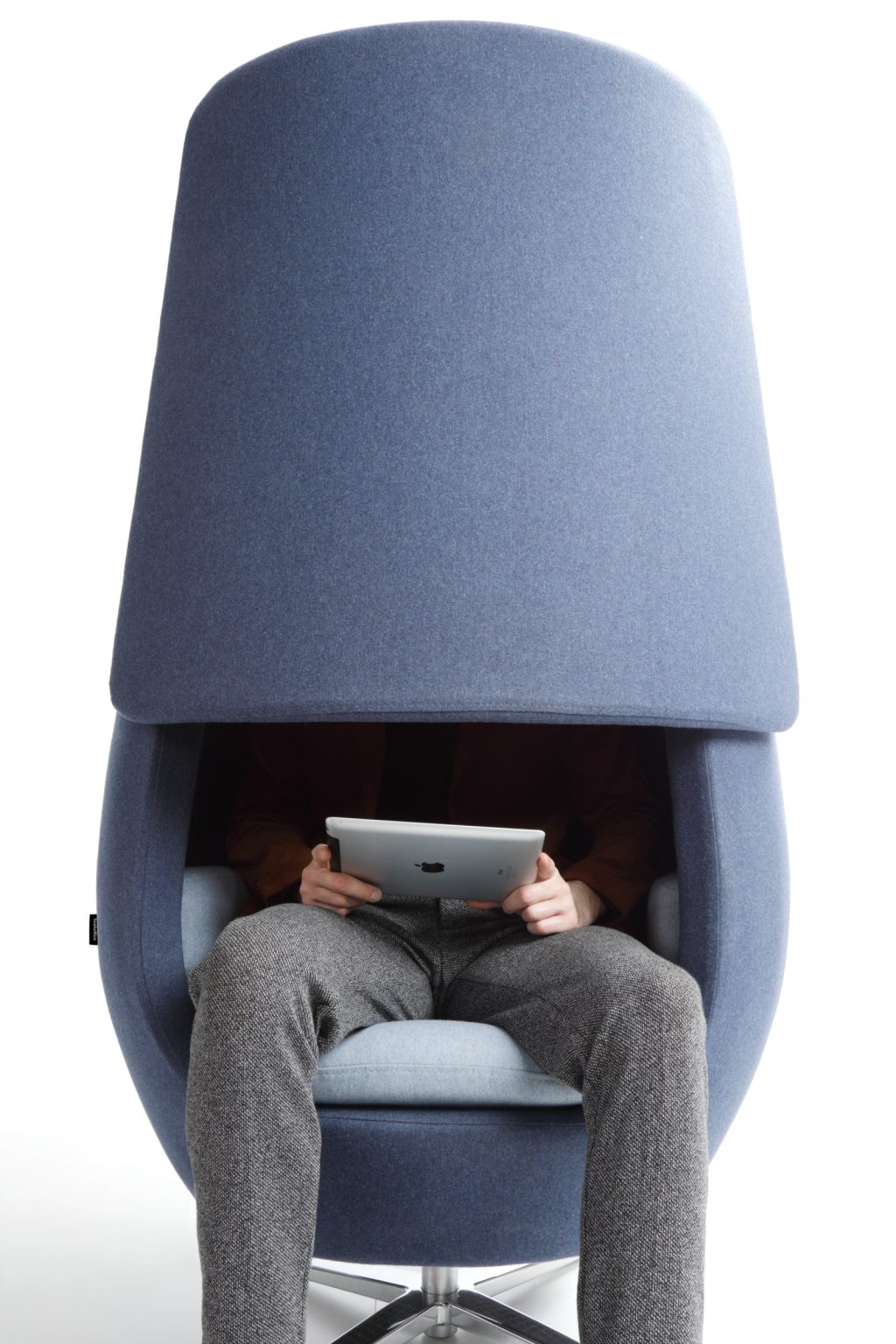 A11 armchair with the panel closed over a person watching a tablet