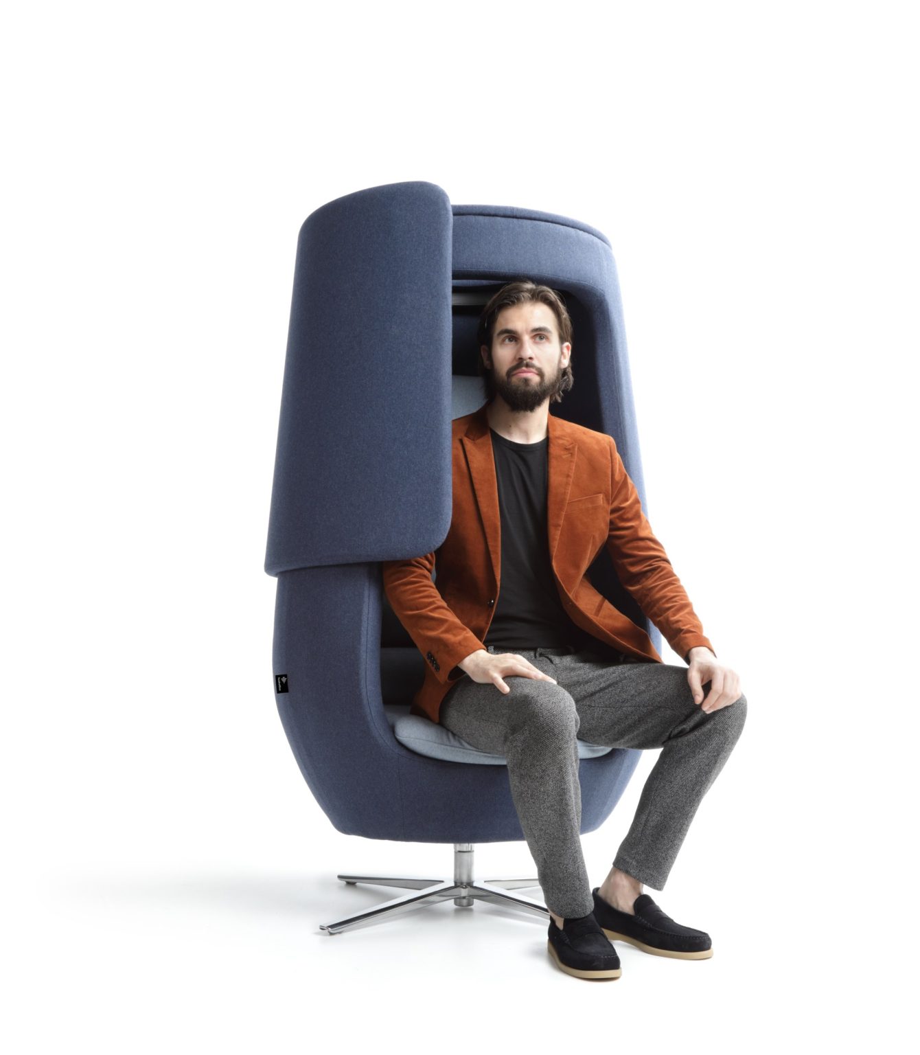 Man sitting in the A11 armchair with the front panel slid aside